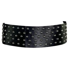 Presenting a wide black Dolce and Gabbana belt. From the early 2000s, this belt is covered in gunmetal studs and features a velcro closure. Approximate measurements: Size - IT42 Belt width: 3.5" Waist: 27" - 30" Luxury Black Corset Belt With Belt Loops, Luxury Black Corset Belt With Belt Included, Black Luxury Corset Belt With Belt Included, Luxury Black Corset Belt For Formal Occasions, Black Luxury Corset Belt For Formal Occasions, Party Belts With Rivets, Black Corset Belt For Evening, Designer Adjustable Black Belt, Adjustable Black Evening Belt