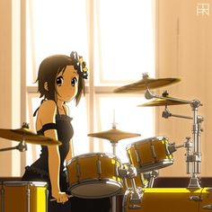 a girl playing drums in front of a drum set