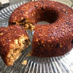 a bundt cake sitting on top of a glass plate next to a slice missing from it