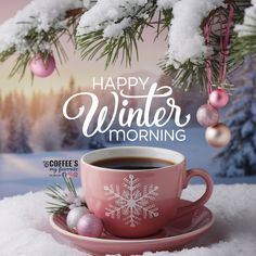 a cup of coffee sitting on top of a saucer next to a christmas tree