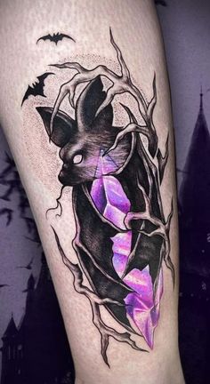 a bat tattoo on the leg with purple flowers and bats around it's neck