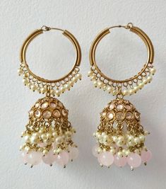 Presenting our Baby Pink Bridal Round Jhumka Earrings, a true embodiment of traditional elegance and grace. These exquisite earrings, adorned with hanging pearls and Polki stones, encapsulate the essence of Indian and Pakistani Chandbali designs, reminiscent of the renowned bridal jewelry style inspired by Sabhyasachi. Materials: Brass, Copper, Pearl, Polki Stones ❋❋ Shipping Methods ❋❋ Standard Delivery - Take up to 8-14 business days (Worldwide). ❋❋ Please be aware that the colors, shades, and texture shown may exhibit minor variations compared to the actual product due to limitations in digital imaging. We kindly ask for your understanding and consideration of these slight discrepancies. ❋❋ Kundan Hoop Earrings With Latkans For Celebration, Traditional Heavy Hoop Earrings For Celebration, Heavy Hoop Earrings For Diwali Celebration, Festive Hoop Earrings With Latkans For Celebration, Festive Round Earrings With Latkans, Festive Round Chandbalis With Latkans, Bollywood Hoop Earrings With Latkans For Celebration, Traditional Hoop Earrings With Cutdana For Celebrations, Heavy Hoop Earrings For Festivals