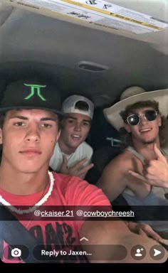 three young men sitting in the back of a car with one pointing at the camera