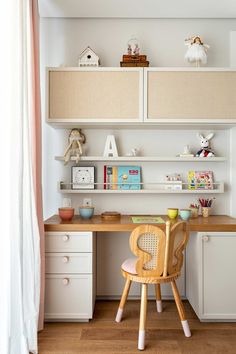 a child's desk and chair in the corner of a room with shelves above it