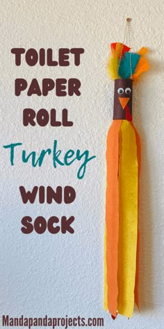 toilet paper roll turkey wind sock hanging on the wall with text reading toilet paper roll turkey wind sock