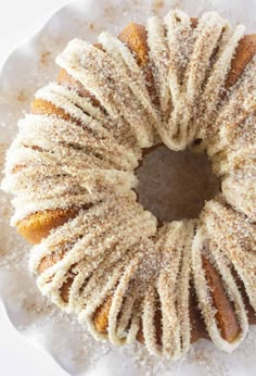 a bundt cake with powdered sugar on top is sitting on a white plate