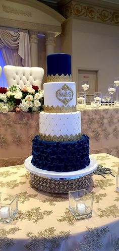 a three tiered wedding cake on top of a table