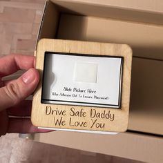 someone is holding up a wooden box with a message on it that says drive safe daddy we love you