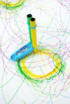 a blue and yellow pen sitting on top of a white table covered in colored circles