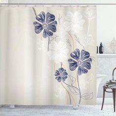 the shower curtain is decorated with blue and white flowers on it, along with a bathtub