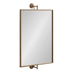 a large mirror hanging on the side of a metal wall mounted cabinet with a light fixture