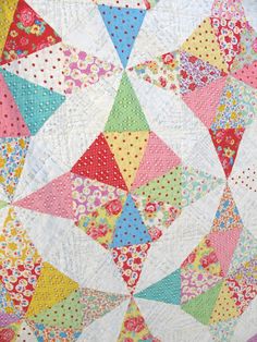 a colorful quilt with many different colors and patterns on it's sides, including the center