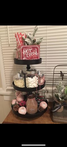 an assortment of candy and candies are displayed on a table in front of a window