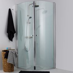 a corner shower stall with a towel hanging on the wall