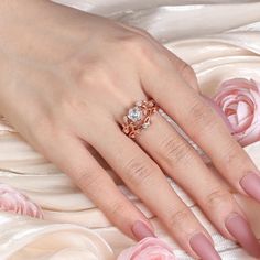 a woman's hand with pink manicured nails and an engagement ring