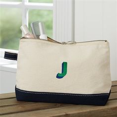 * Embroidered with any name , initial, or monogram * Choose from multiple thread colors and font options * Thread colors shown are emerald green and navy blue  * Quality crafted of 12 oz. medium-weight natural canvas with a silver zipper pull. * Colored trim lines the bottom of the bag keeping it neutral to coordinate with any outfit or occasion. * Measures 11L x 3W x 7H * Hand wash cold. Lay flat to dry * Imported Whether you are looking for a travel accessory or an everyday makeup bag, call it Personalization Mall, Colored Trim, Name Canvas, Canvas Makeup Bag, Embroidered Canvas, Personalized Canvas, Personalised Canvas, Thread Colors, Silver Zipper