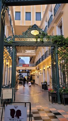 an entrance to a building with people walking around