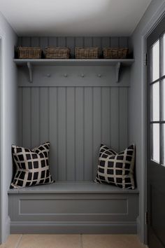 two pillows are sitting on a bench in the hallway