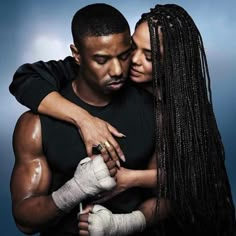 a man and woman hugging each other in front of a blue background with white gloves on