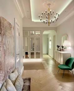 a living room filled with furniture and a chandelier