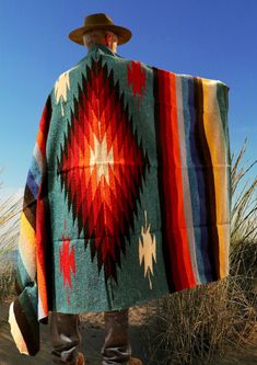 a person with a colorful blanket on their back