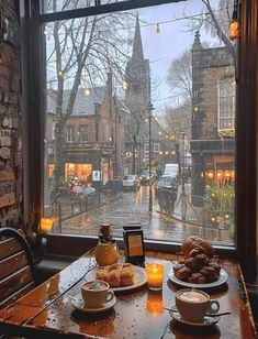 two plates of food sit on a table in front of a window overlooking a street