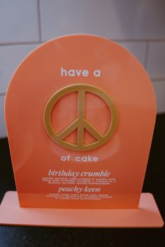 an orange peace sign with the words have a piece of cake on it