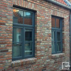 a brick building with three windows on each side