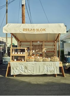 an outdoor food stand with bread on it