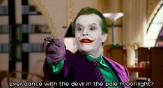 the joker is pointing at something with his hand and saying, ever dance with the devil in the pale moonlight?