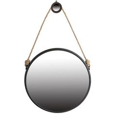 a round mirror hanging from a rope