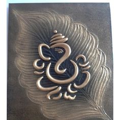 an intricately designed metal plaque with the letter s on it