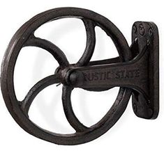 an old fashioned cast iron wall hook with the words rustic state on it's side