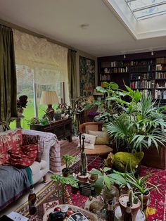 a living room filled with lots of plants and furniture