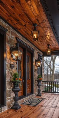 a porch with wooden floors and lanterns on the ceiling