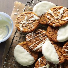 cookies with white icing on a cooling rack