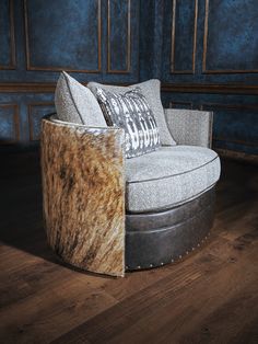 a chair that is sitting on top of a hard wood floor in front of a blue wall