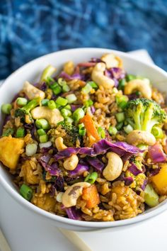 a white bowl filled with rice and vegetables