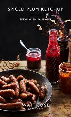 there is a bowl full of hot dogs next to some ketchup and sauces