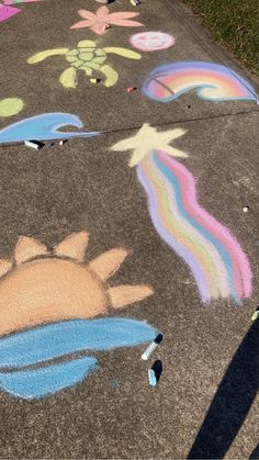 the sidewalk has been decorated with chalk and crayons for children to draw on