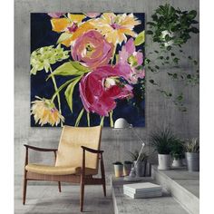 a chair sitting in front of a painting on the wall next to a potted plant