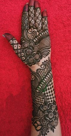 a woman's hand is decorated with hennap and intricate designs on it