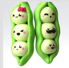 two peas with faces painted on them are in the shape of a couple of peas