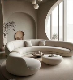 a living room filled with white furniture and large round mirrors on the wall above it