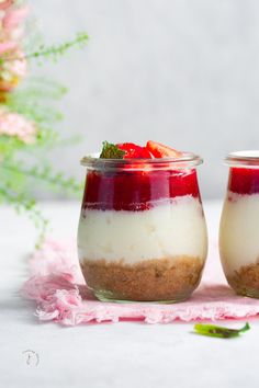 two small jars filled with food on top of a table