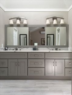 a large bathroom with double sinks and mirrors