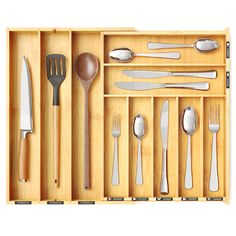 a wooden drawer with utensils and spoons in it