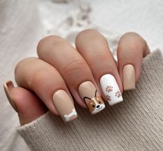 These short square nails bring a touch of cuteness with a puppy theme, featuring paw prints and a dog face. The soft gel finish in neutral tones keeps it simple yet adorable, with a white accent nail to make the design pop. Perfect for animal lovers, this unique acrylic look adds a bit of fun to your fall nails. The short length makes it a practical choice for everyday wear. Cute Accent Nail Designs, Nail Art For Square Nails Shape, Dog Themed Nails Art Ideas, Fall Fun Nails Ideas, Pet Nail Art, Boston Terrier Nail Art, Cute Dog Nails, Cute Nail Acrylic Designs, Animal Design Nails