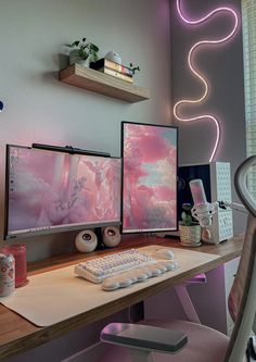 two computer monitors sitting on top of a wooden desk