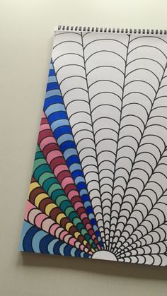 a spiral notebook with colored lines on it